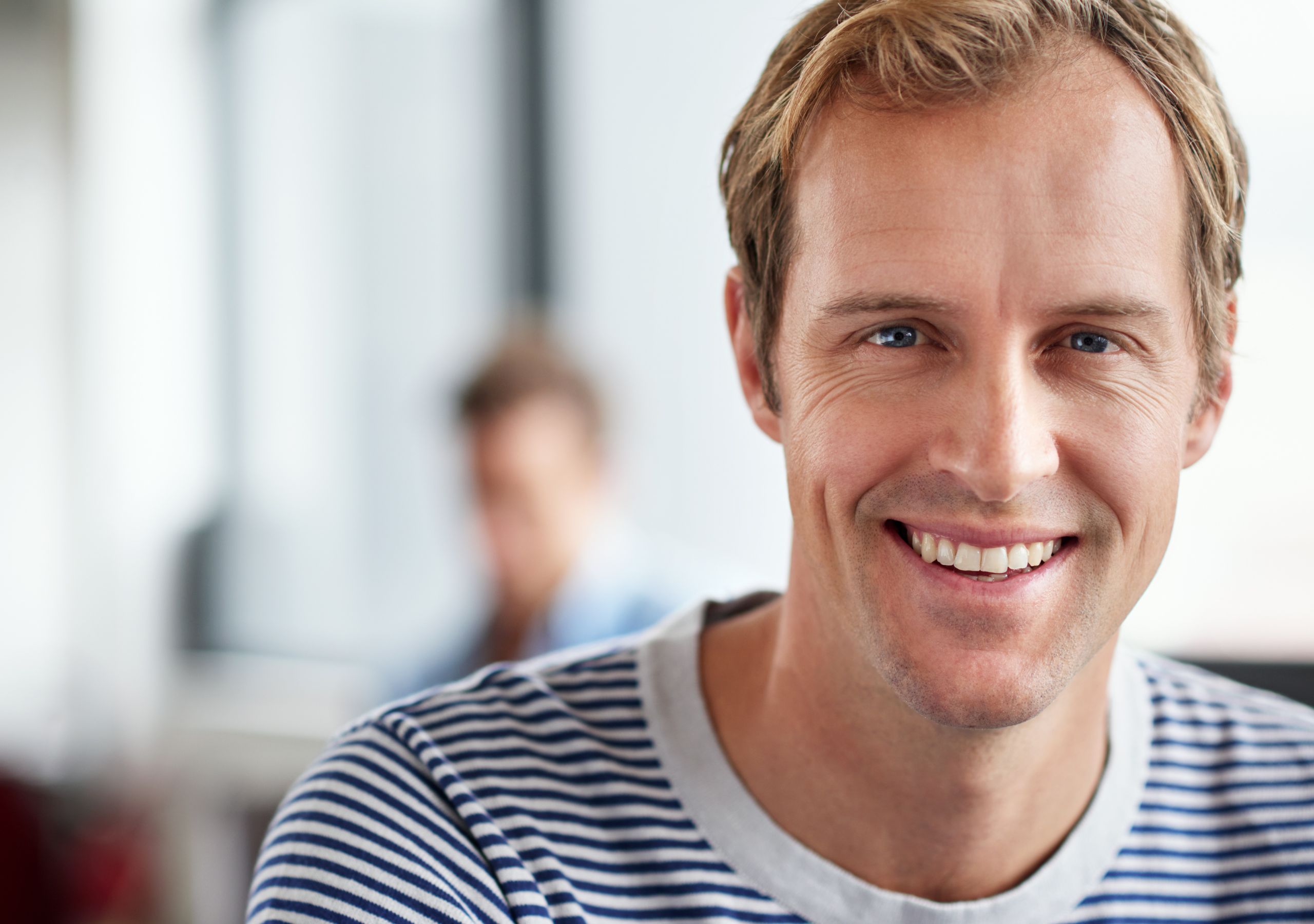 A Man Smiling After Receiving Gum Disease Treatments