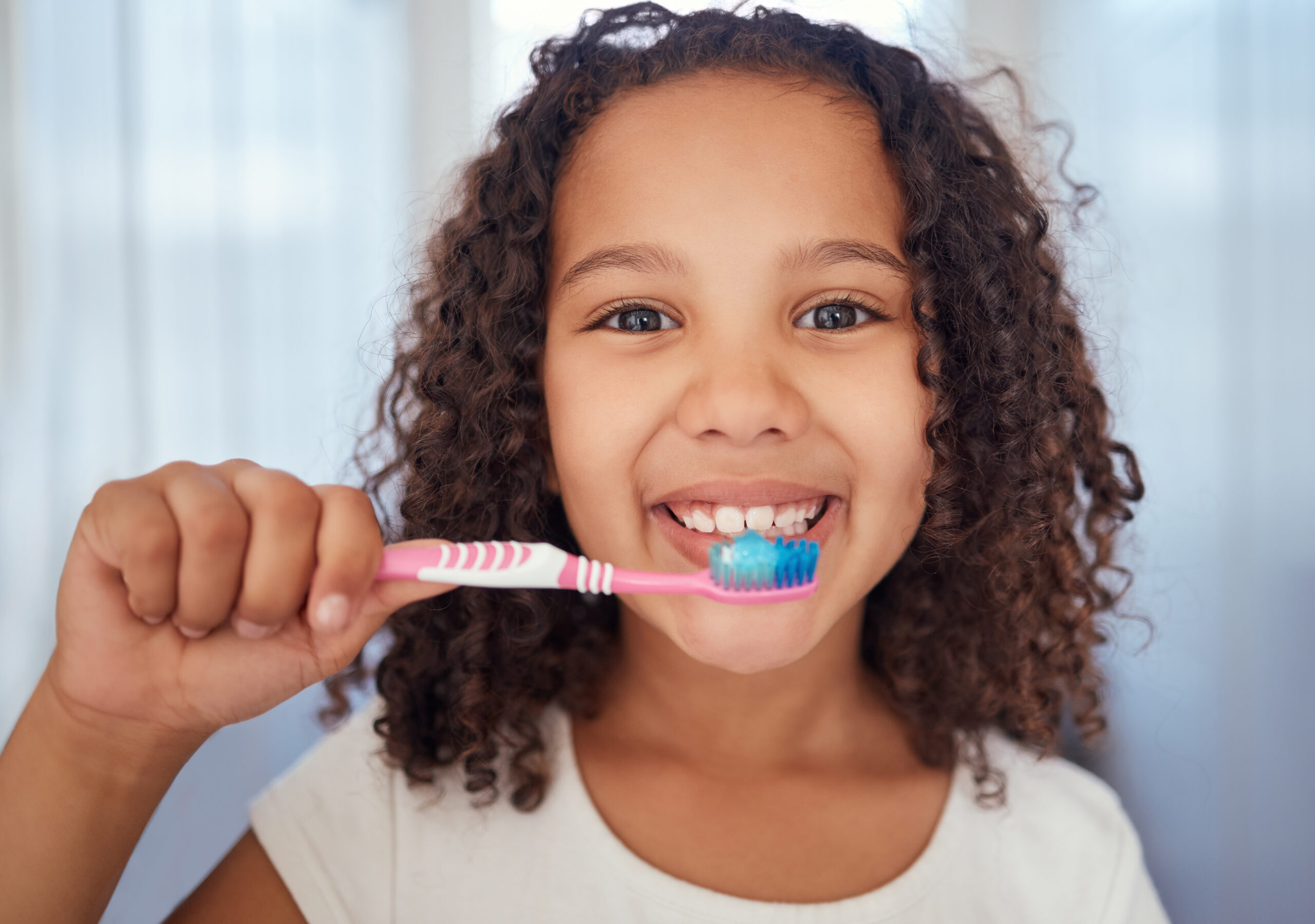 Girl brushing her teeth and flossing in Pinole, CA